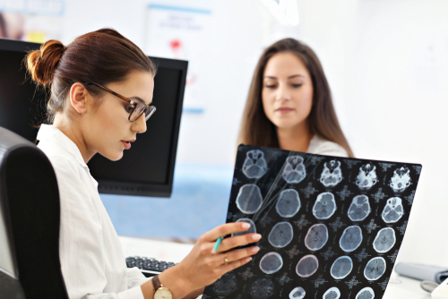 Adult,Woman,Discussing,X-ray,Results,During,Visit,At,Female,Doctor's